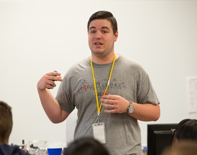 SIUE SOP third-year student Dalton Dieckow engages high school students in thinking about pharmacy as a future career path.