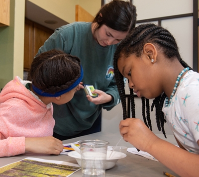 SIUE Environmental Sciences Graduate Assistant and Watershed Nature Center Environmental Educator Danielle Kulina shows students how to measure pH levels.