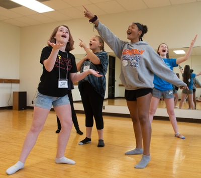 Cougar Theater Camp participants joyfully act out a scene from Frozen, Jr. (L-R) Maggie Rice, Ariee Morse, Kaela Johnson and Laura Perry.