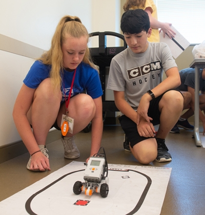(L-R) Ella Bockhorn, of Waterloo, and Graham Smith, of O’Fallon, team to defeat a robotics challenge.