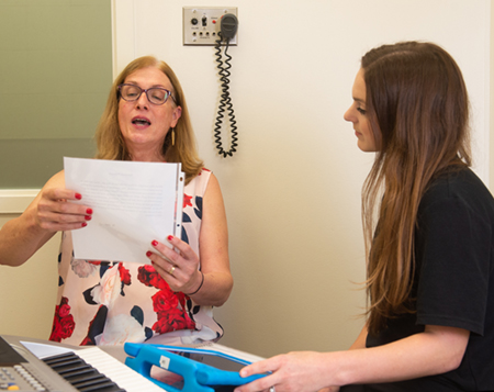 SIUE Speech-Language-Hearing Center client Billie Maupin (left) practices an exercise during a voice therapy session with graduate student clinician Tess Spengler.