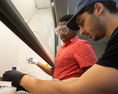 SIUE graduate student Carl Namini assists Malachi Moyegun, a sophomore home school student from Edwardsville, prepares DDT-coated glass vials for the fly knockdown bioassays.