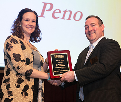 SIUE alumna Ashlee Peno accepts the Outstanding Alumna in Civil Engineering (CE) award from CE professor and department chair Ryan Fries, PhD.
