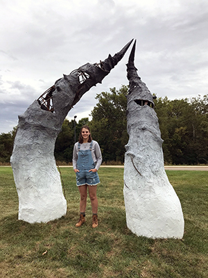 SIUE’s Abbi Ruppert stands on campus by her installed sculpture, entitled “Revival.”