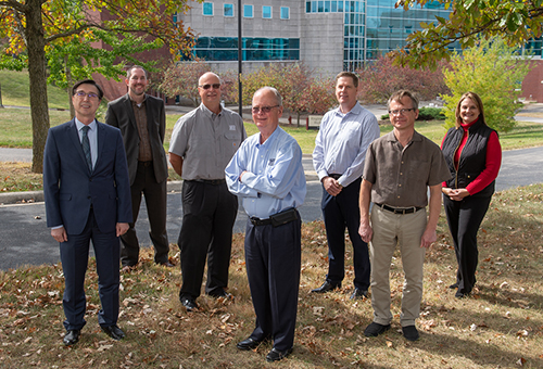 (L-R) Standing outside the SIUE School of Engineering (SOE) are Basler Electric’s Chairman of the Board and Treasurer Bill Basler (center), Vice Chairman of the Board and CEO Greg Basler (middle left) and President and COO Ken Rhodes (middle right). On their left are SOE Dean Cem Karacal, PhD (far left) and Associate Dean Chris Gordon, PhD, and on their right, Chair of the Department of Electrical and Computer Engineering Andy Lozowski, PhD, and SOE Director of Development Lisa Smith (far right).