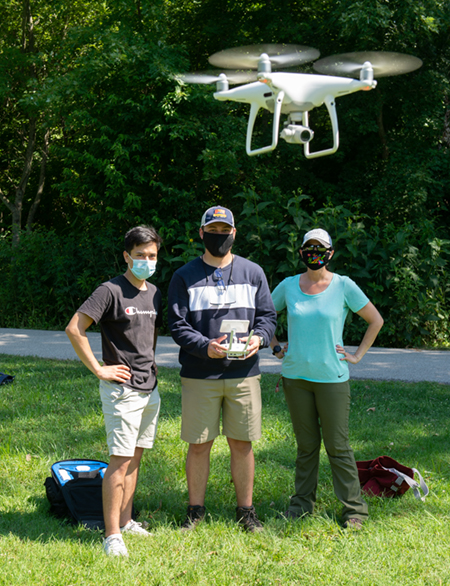 SIUE geoscholars Jesus Sanchez and Logan Pelo use a drone to photograph land cover at the Watershed Nature Center. Looking on is GEOPATHS co-PI Adriana Martinez, PhD, associate professor in the Departments of Environmental Sciences and Geography.