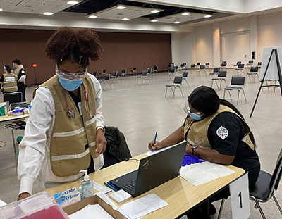 SIUE SON students prepare their station for individuals to receive the COVID-19 vaccination.