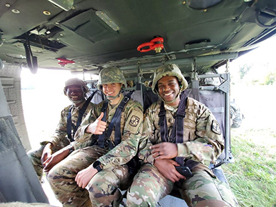 SIUE ROTC Cadet and Army Aviation Officer Kevin Kerkemeyer (center) sits with fellow cadets in an Army aircraft. (photo taken pre-COVID)