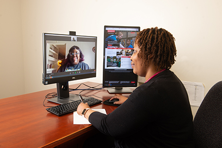 SIUE WE CARE Clinic Nurse Practitioner Chaney Bell hosts a telehealth appointment with an on-screen patient.