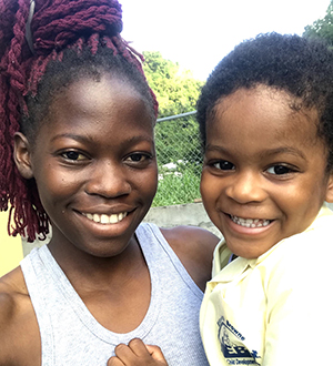 SIUE international student Sorenya Miller holds her nephew, whom she helped care for, in St. Vincent.