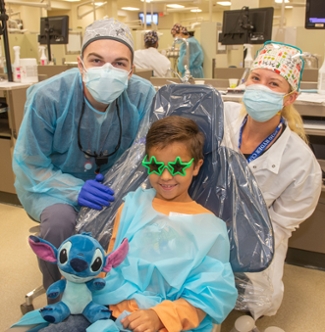 A child receives dental care during the SIU SDM’s Give Kids a Smile Day event. 