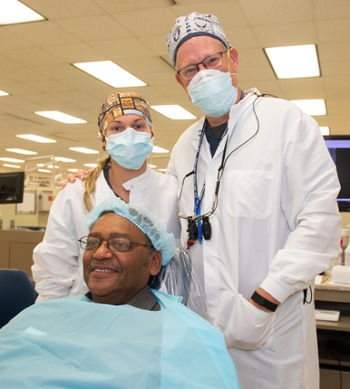 SIU School of Dental Medicine fourth-year student Tabitha Hanson and clinical professor David Pierson provided free dental treatment for patient William Thompson during the annual Veteran’s Care Day event. All are U.S. veterans.