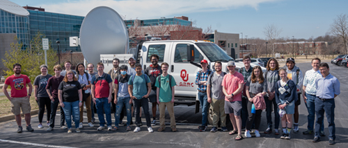 SIUE students and faculty, and collaborators from the University of Oklahoma, gather near a mobile radar unit that was hosted on campus.