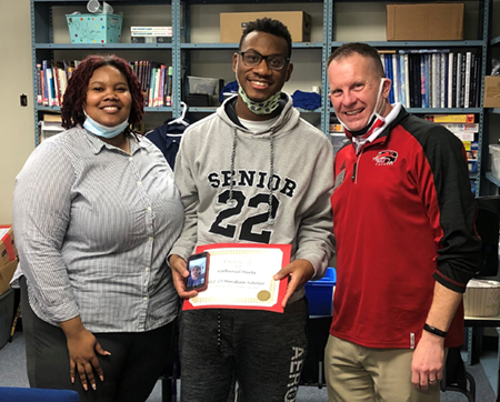 Nathaniel Marks, a senior at McCluer North High School was surprised with his receipt of SIUE’s Meridian Scholarship. (L-R) Del’Brica Flowers, SIUE admission counselor, Marks, and Todd Burrell, SIUE director of Undergraduate Admissions.