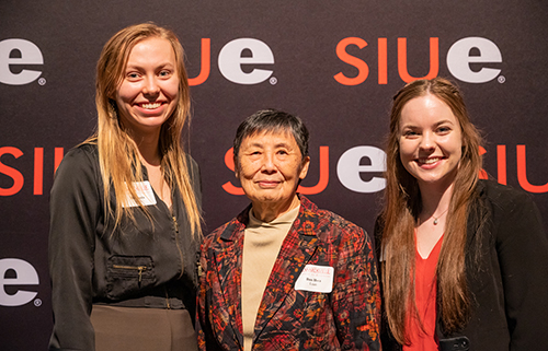 Scholarship recipients Mickenzie Bass (left) and Kelly Cruise (right) stand with Mrs. Buo Hwa Luan.