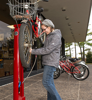 A student uses one of the University’s bike repair stands, which is equipped with a full set of bike-specific tools that are freely available and highly accessible at locations across campus.