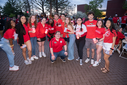 A group of students join staff member Brandon Sweeney (front) for a photo during the One Day, One SIUE event.