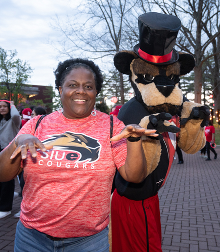 An SIUE supporter celebrates with Eddie the Cougar at the evening event.