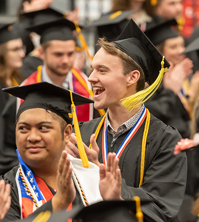 Jakob Ruffner celebrates with fellow graduates during the spring 2022 commencement ceremonies.