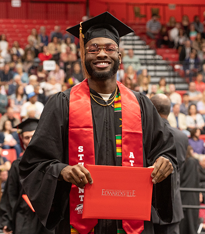 An SIUE student-athlete poses with his diploma.