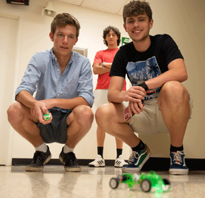 (L-R) Senior James Paris, of Alton, and senior Wyatt Hume, of Winfield, work together on testing their fuel cell car.  