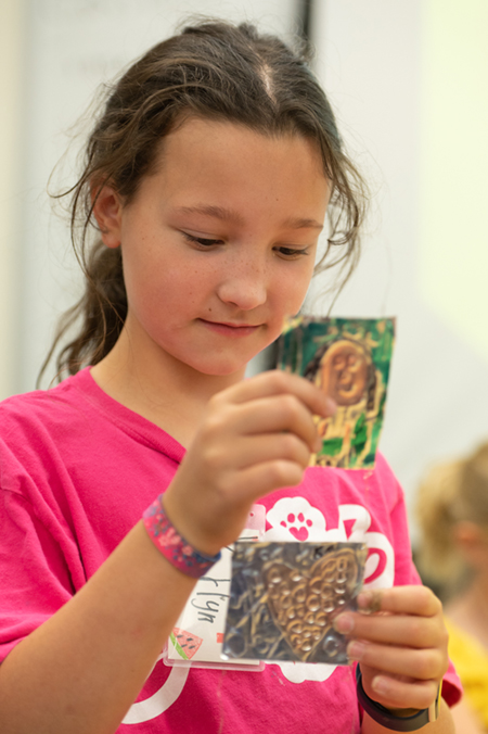 Karlyn Morgan, of Collinsville, admires her creation during SIUE’s Summer Arts Camp.