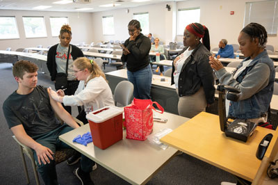 Attendees of the School of Pharmacy’s HBCU Pharmacy Careers Retreat observe how to administer injections.