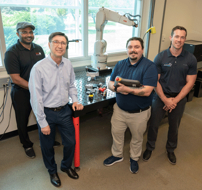(L-R) Jagath Gunsekera, PhD, lab manager and instructor in the Department of Industrial and Mechanical and Mechatronics Engineering, Cem Karacal, PhD, dean of the School of Engineering, Tyler Thorpe and John Weidner with Amsted Rail. 