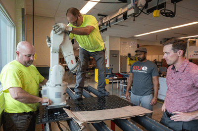 Installation of the robotic arm donated by Amsted Rail.