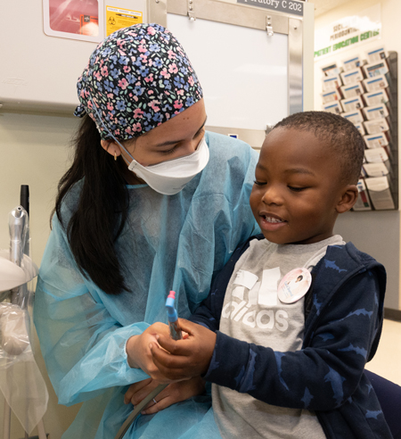 SIU SDM dental student provides free dental care during the SIU SDM’s Give Kids a Smile Day. 