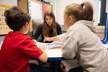 Skyler Bailey, junior elementary education major from Auburn, works with local elementary students on math concepts.
