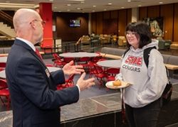 College of Arts and Sciences Dean Kevin Leonard, PhD, engages with students during a Donuts with the Dean event.