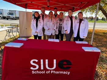 SIUE School of Pharmacy students assist with food distribution and provide free health checks at a local food pantry. 