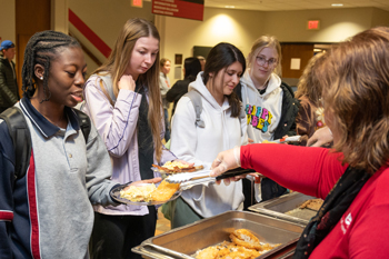 SIUE faculty and staff serve students at a late-night breakfast to help prepare them for finals.