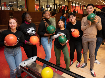 Students participate in bowling and other games during the international student welcome party. 