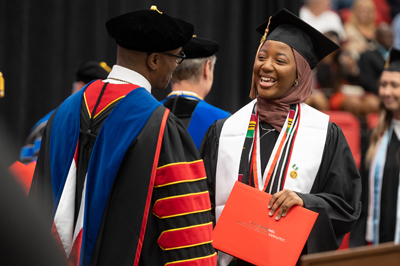SIUE School of Business student walks across the stage earning her degree. 