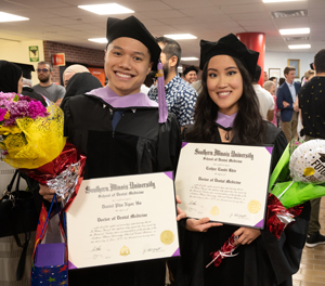 Graduates celebrate earning their degree.