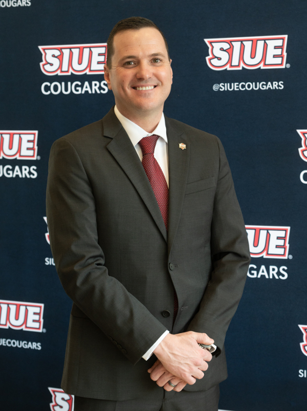 Andrew in front of step and repeat