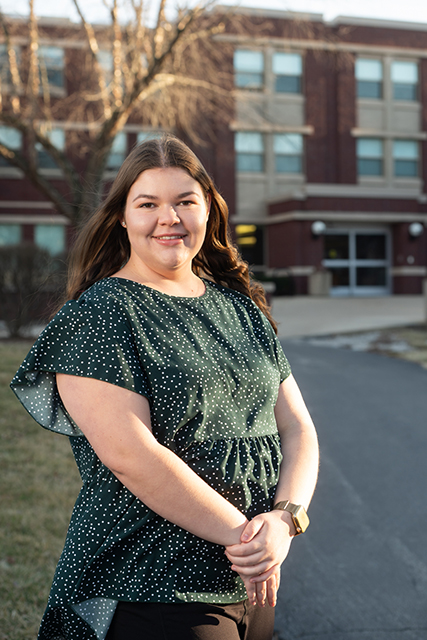 Portrait of Brienna Weaver Standing outside Woodland Hall