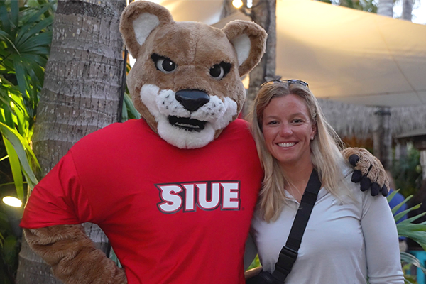 Jackie Gover poses with Eddie the Cougar