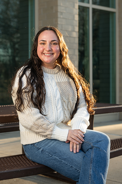 Sophie Parson sitting outside of Woodland Hall