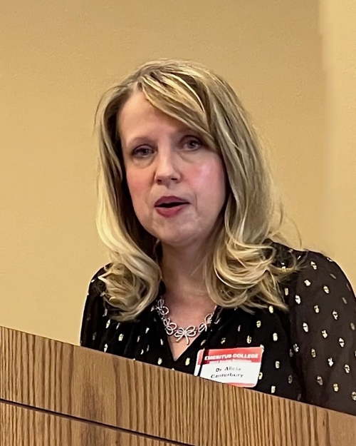 Canterbury speaking at podium