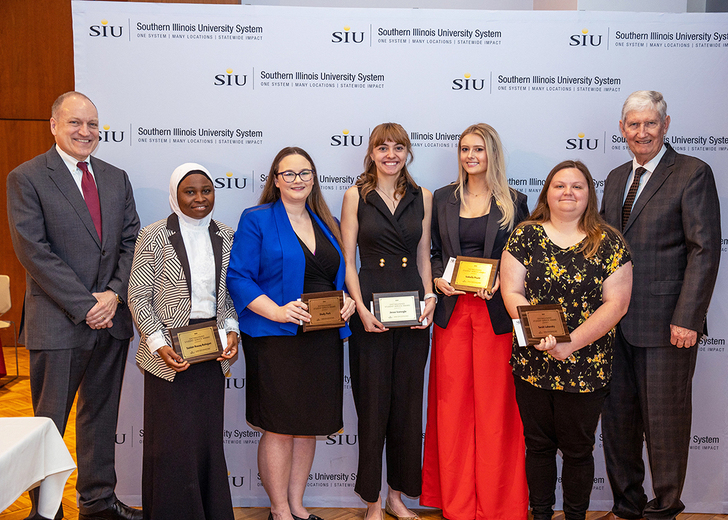 Group of Honored students with Mahony and Board of Trustee Chair, Gilbert
