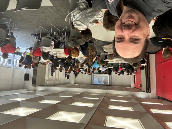 Dr. Tim Jacks takes a selfie with high school students in the background at Cybersecurity Career Day at SIUE