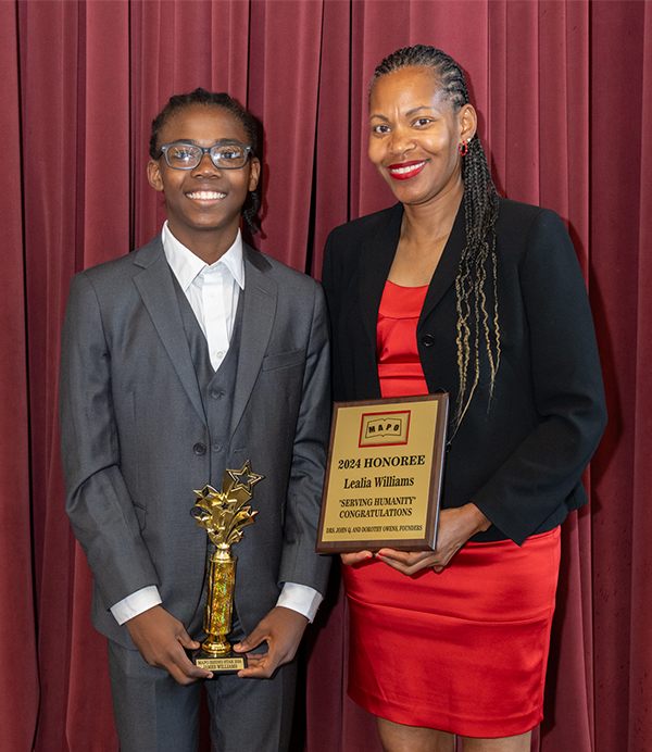 Lealia and son James Williams stand with MAPO award