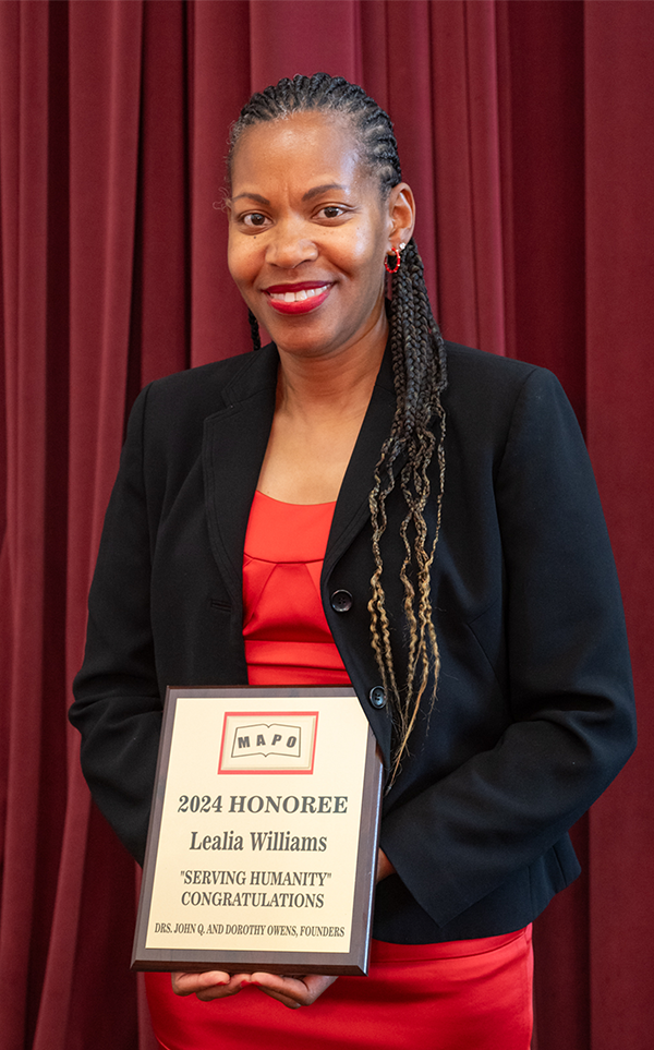 Lealia Williams stands with her award