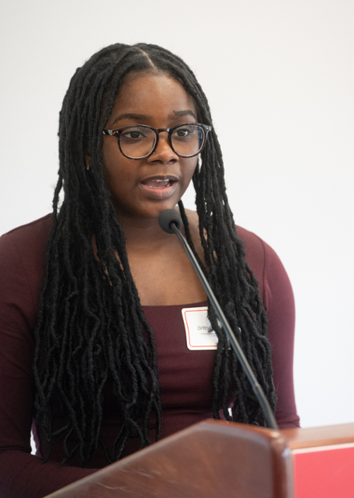 Wallace speaking into the microphone