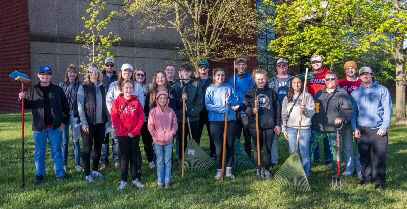 School of Pharmacy yard crew stands for group photo with tools