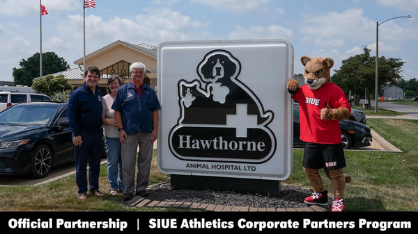 Eddie with people and animal hospital sign on lot