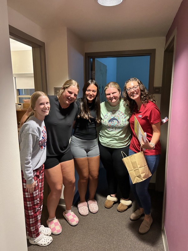 Group of residents in hallway posing for photo